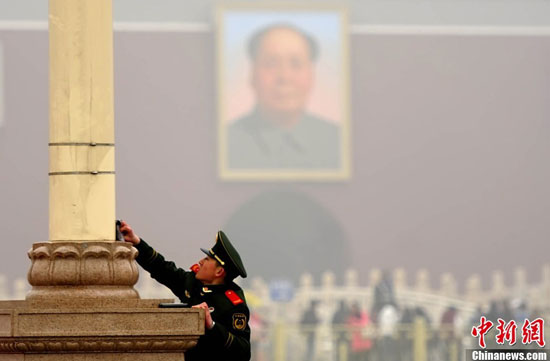 2月28日，北京武警正在擦洗天安门广场设施，迎接即将召开的全国两会。中新社发 陆欣 摄
